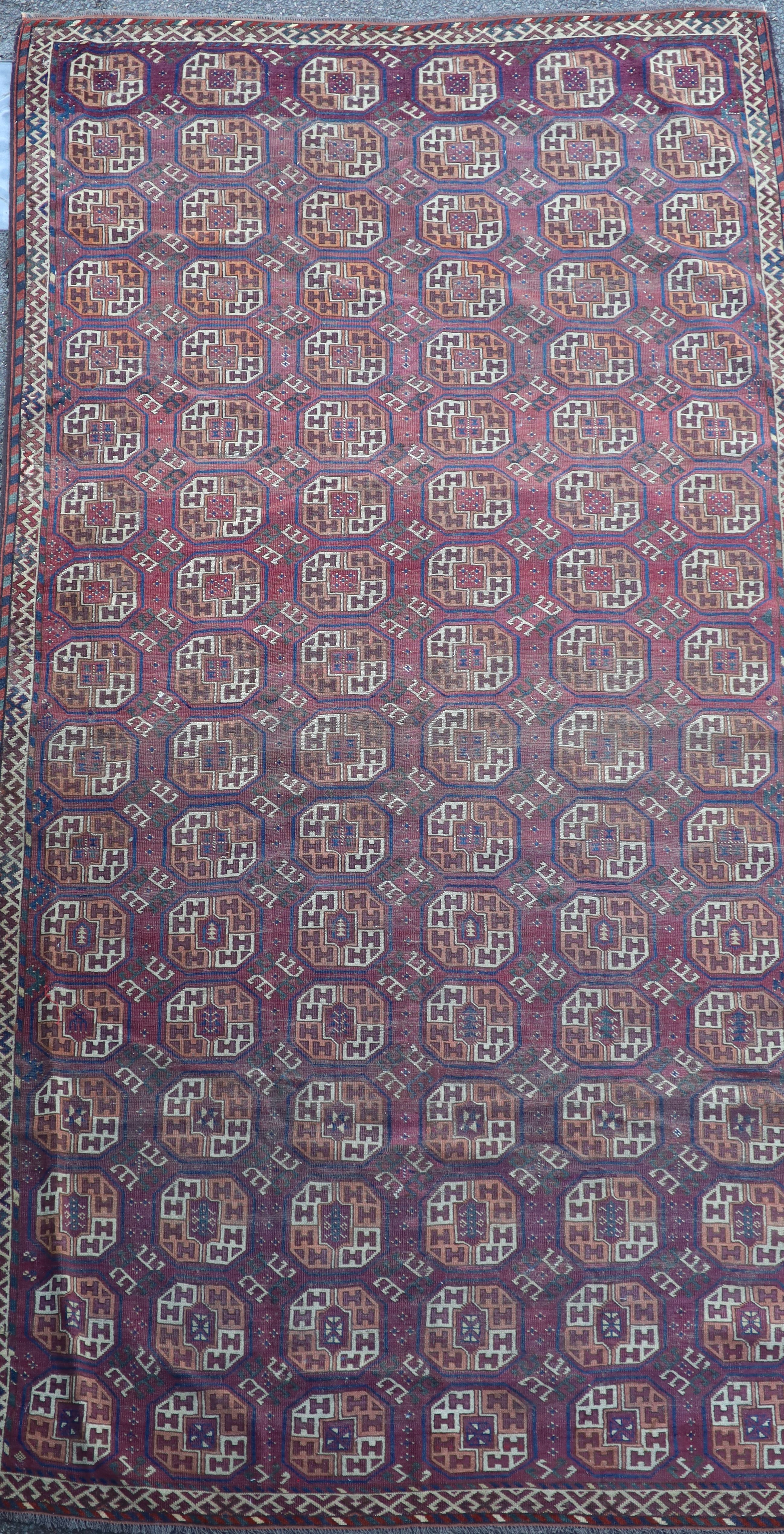 A Bokhara burgundy carpet, 356 x 184cm
